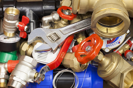 Brass plumbing valves and fittings with an adjustable wrench